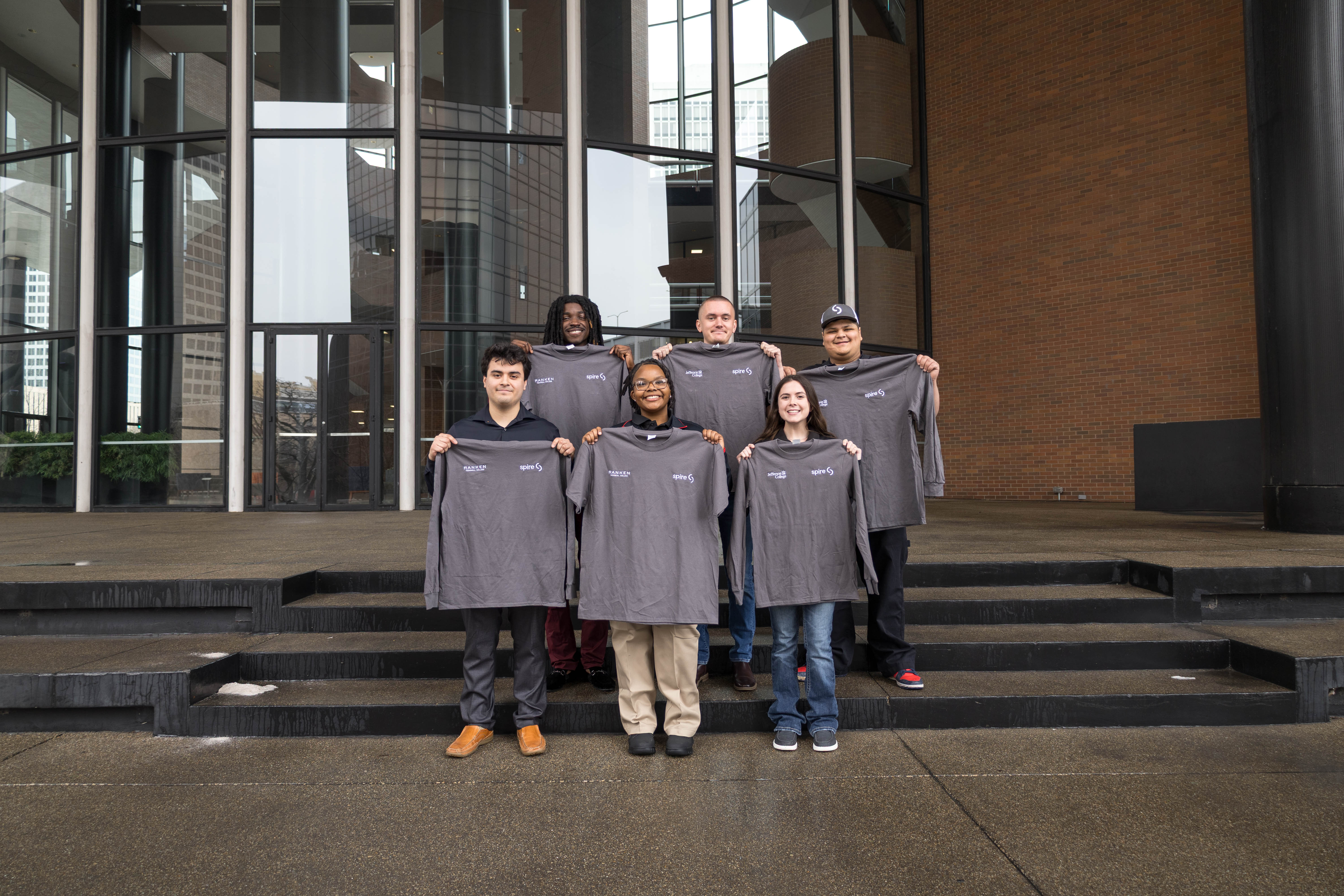 Image of students holding their new uniforms