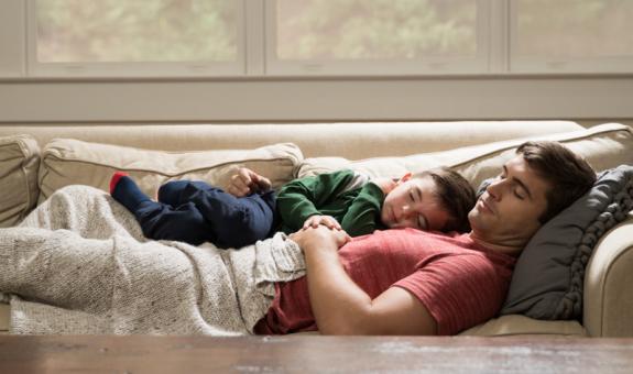 Family snuggling on couch