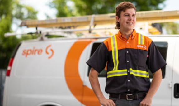 Image of Spire service technician in front of Spire service van