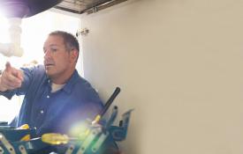 Image of: Contractor pointing to equipment