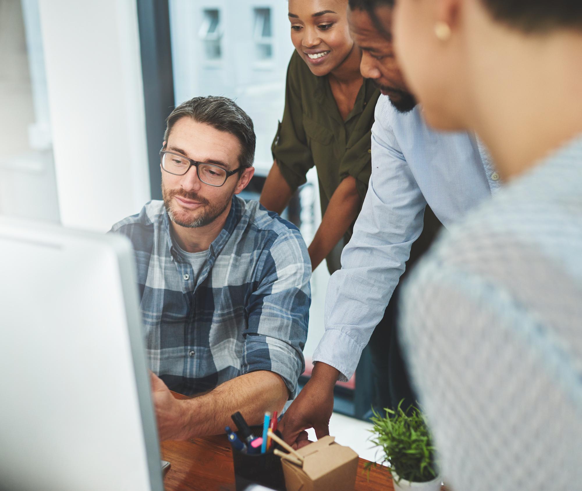 Benefits Business people around computer