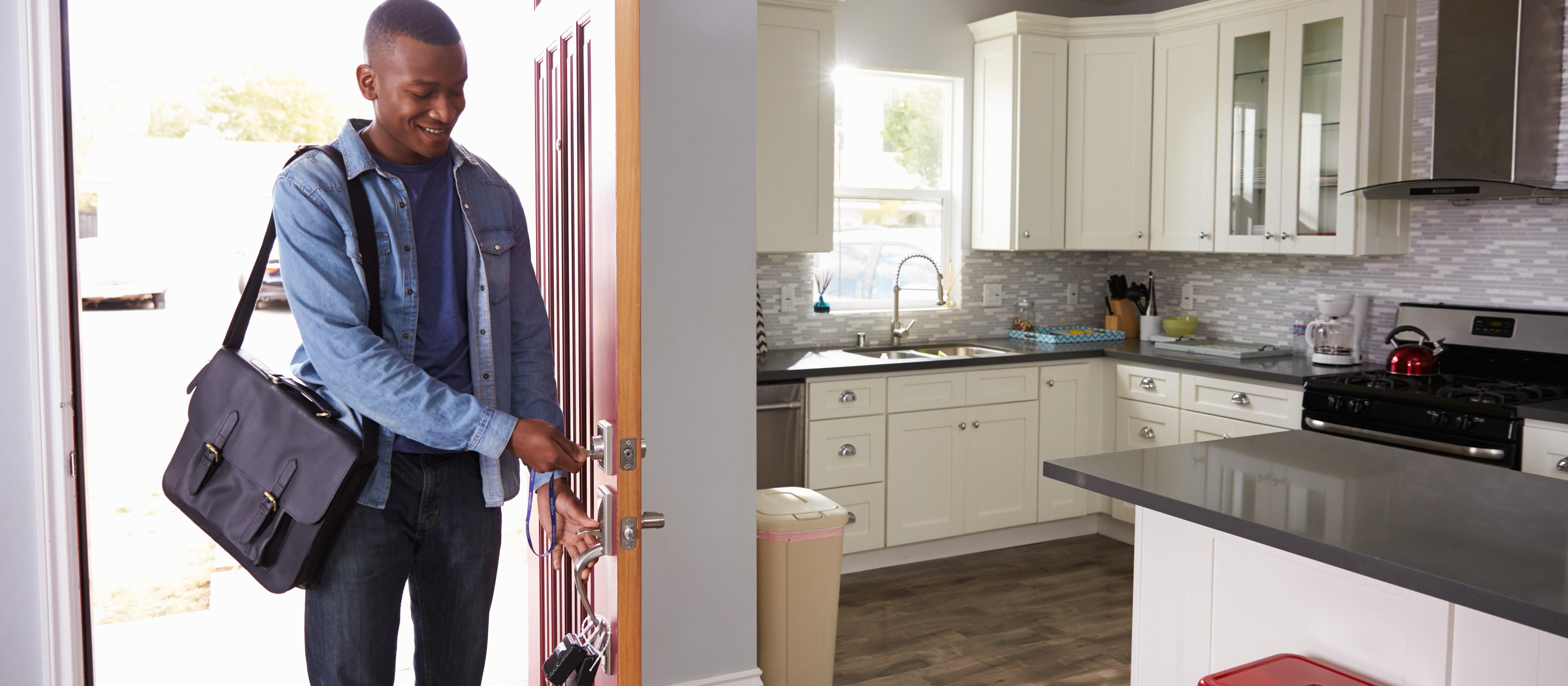Man opening the door to new home