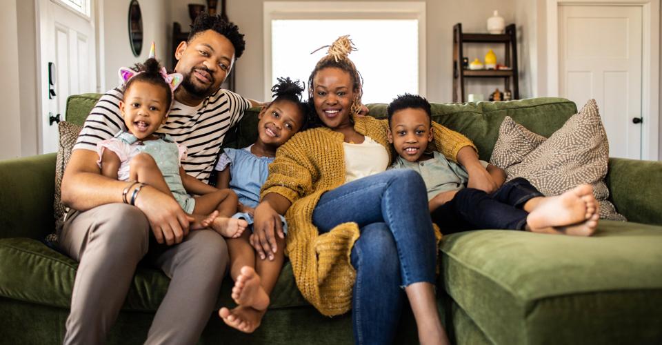 Image of family cuddling together on the couch