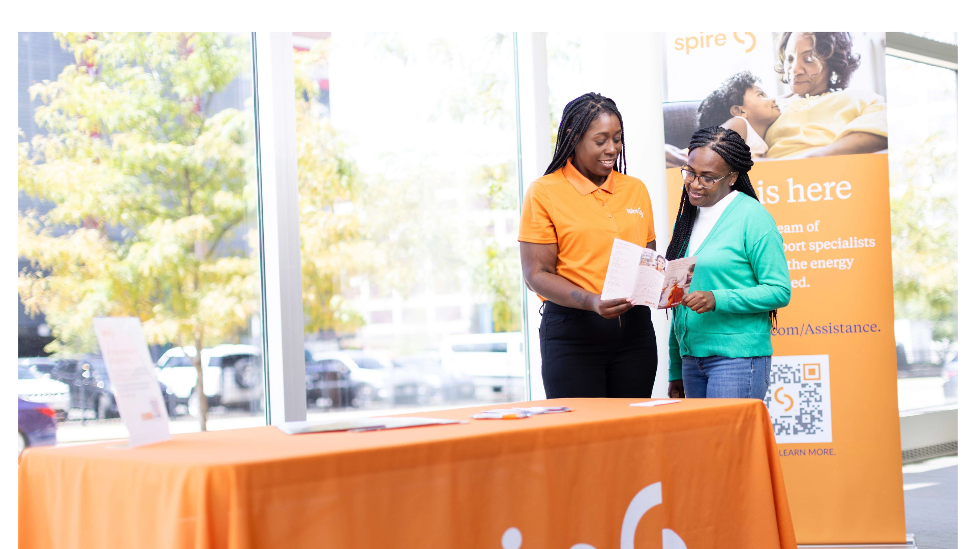 Image of Spire employee helping a customer at a community event
