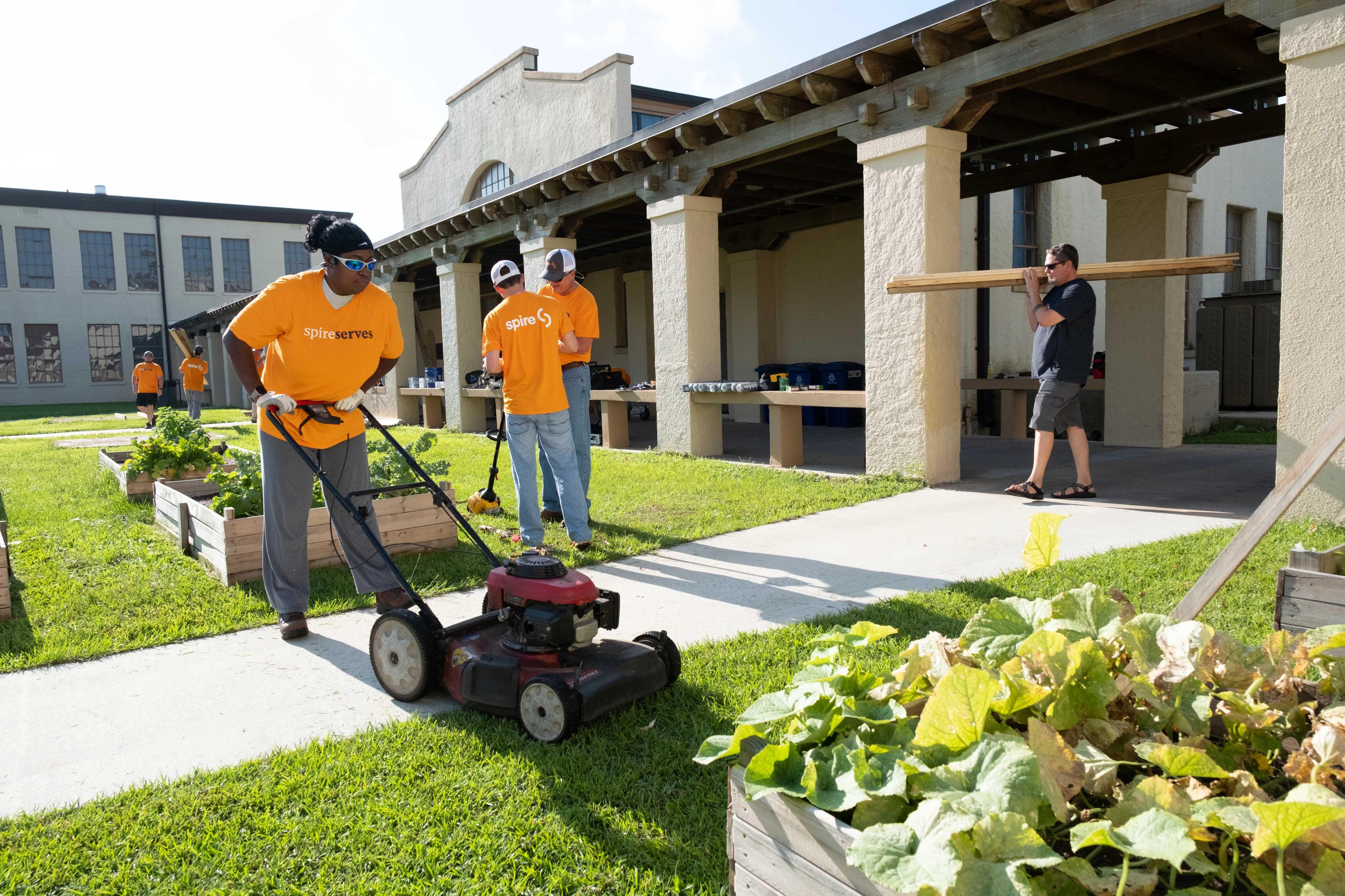 spire employees at murphy high working in garden
