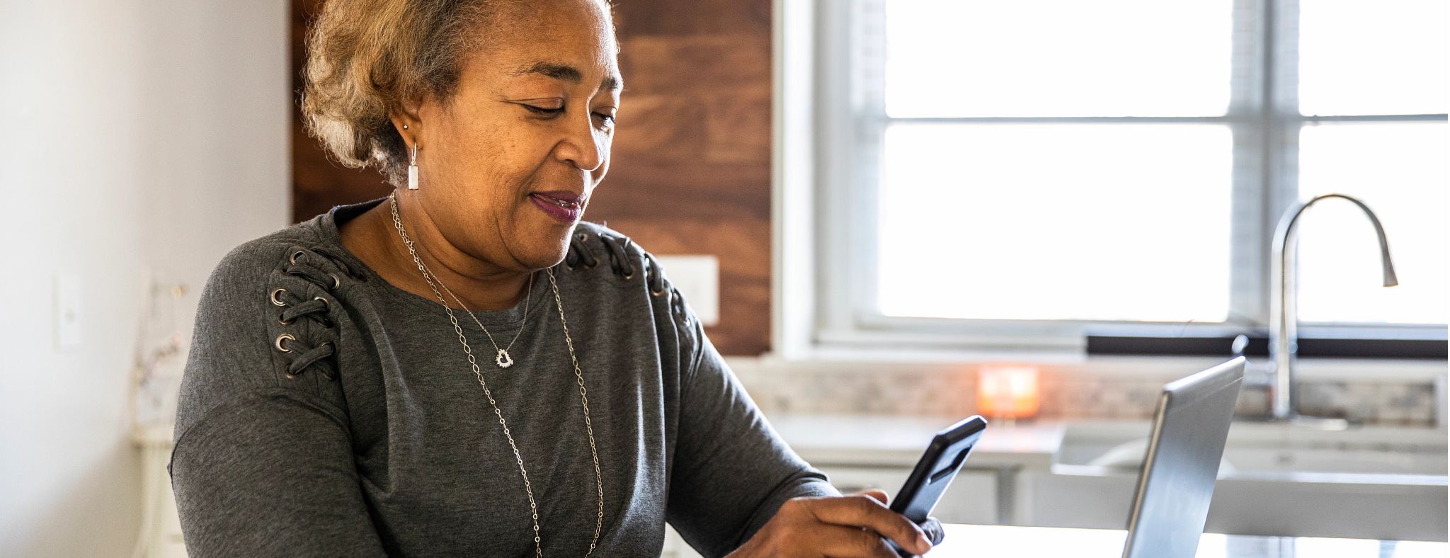 Image of woman looking at her phone