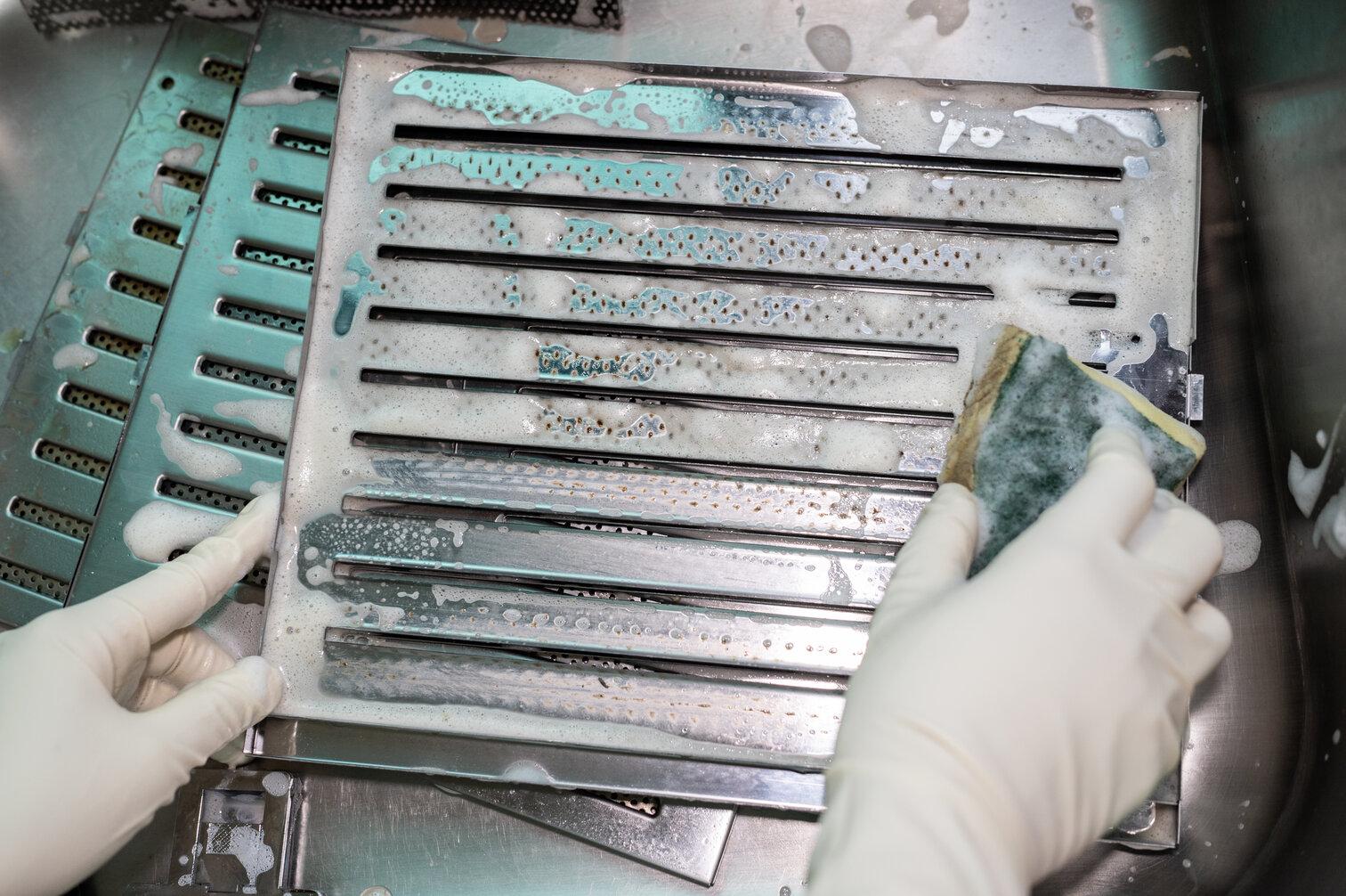 Image of person cleaning grease trap