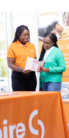 Image of Spire employee helping a customer at a community event