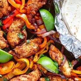 image of fajitas and a tortilla on a sheet pan